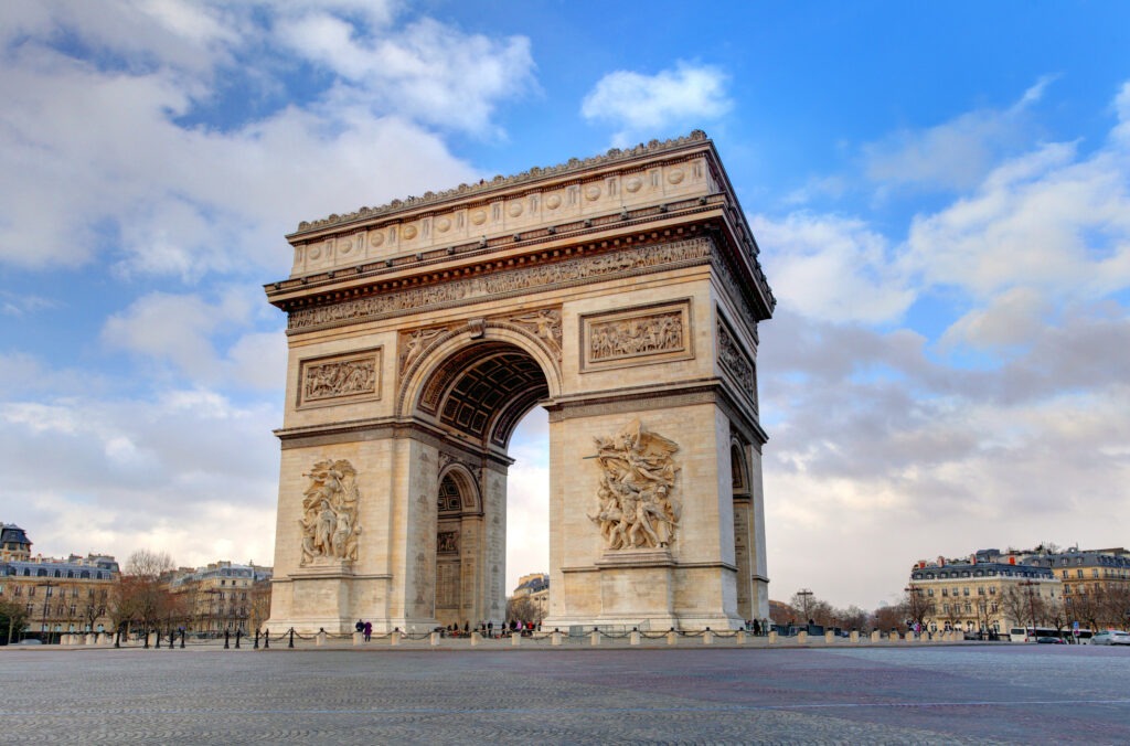 Der Arc de Triomphe in Paris, ein monumentaler Triumphbogen auf der Champs-Élysées, umgeben von einem Kreisverkehr.