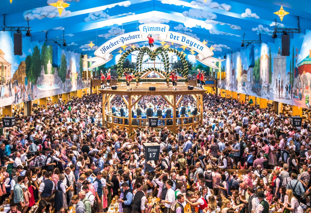 Festzeltstimmung auf dem Oktoberfest in München – Besucher genießen bayerische Musik im Hacker-Pschorr-Zelt bei Bier und guter Laune.